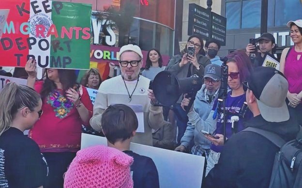 Ben Cable speaks at International Women's Day Rally in Las Vegas surrounded by crowd